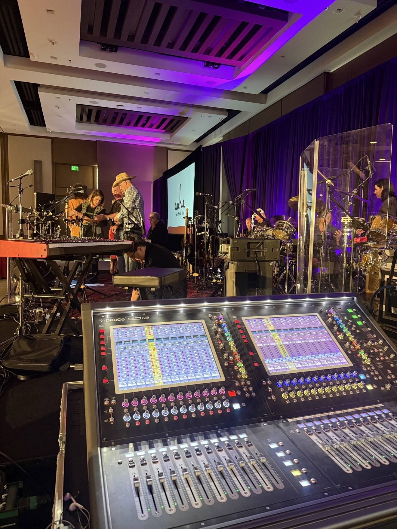 DiGiCo mixing console at front of house with the band on stage