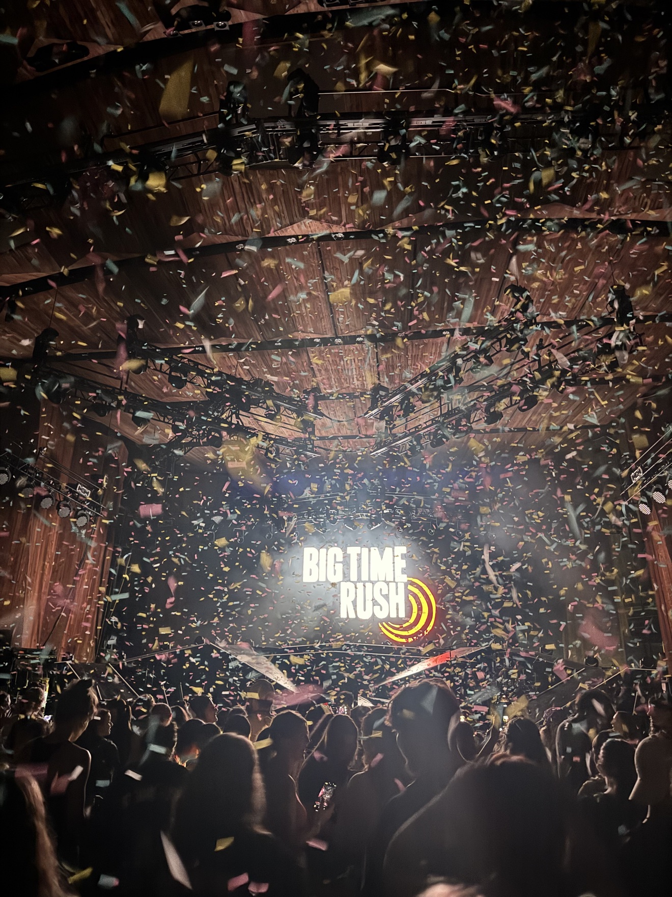 Concert stage during a Big Time Rush performance with confetti filling the arena