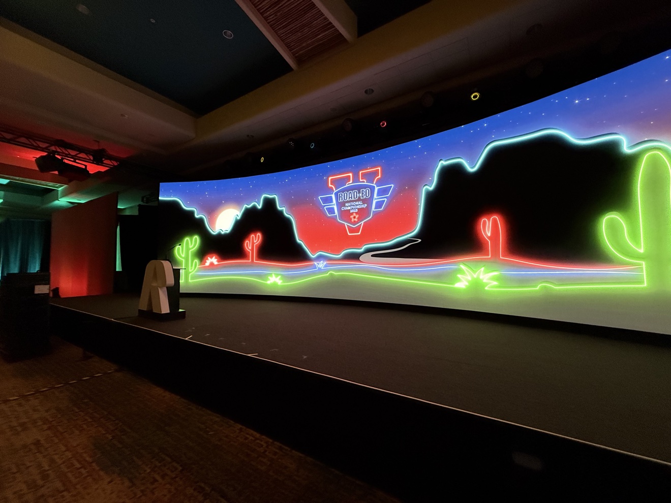 Large LED wall displaying bright desert-inspired neon graphics