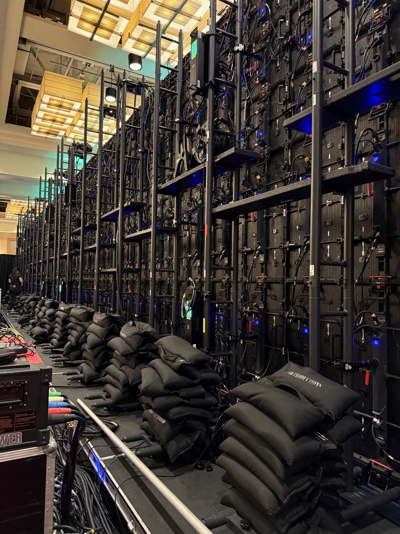 Rear view of structural rigging and cabling behind an LED video wall