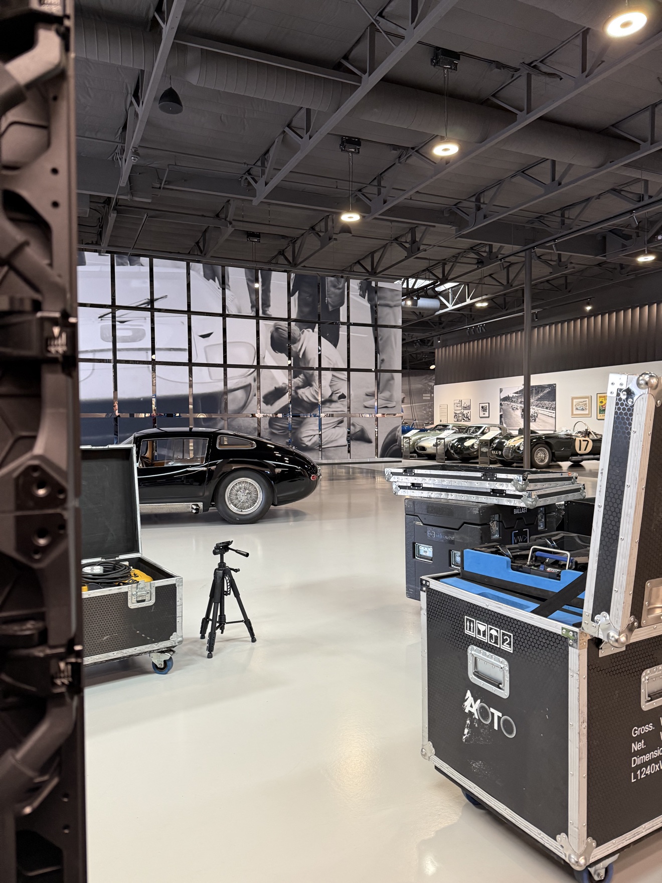 Live event production setup staged alongside classic cars