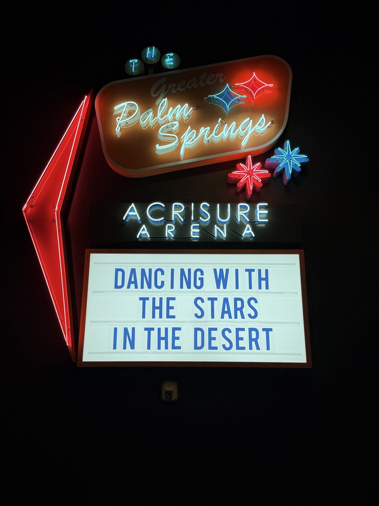 Palm Springs Acrisure Arena neon sign illuminated at night