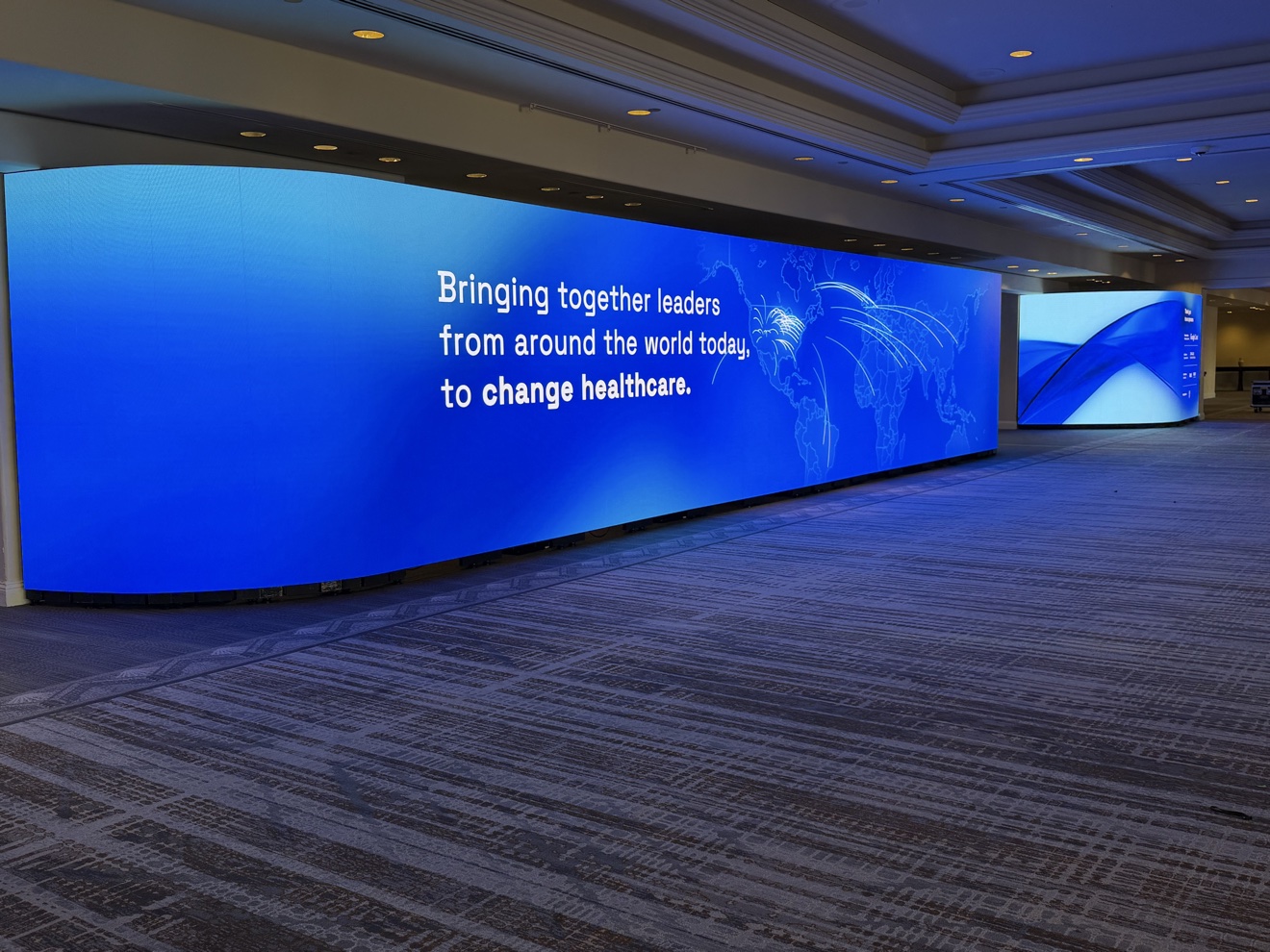 Healthcare conference stage with a curved LED video wall