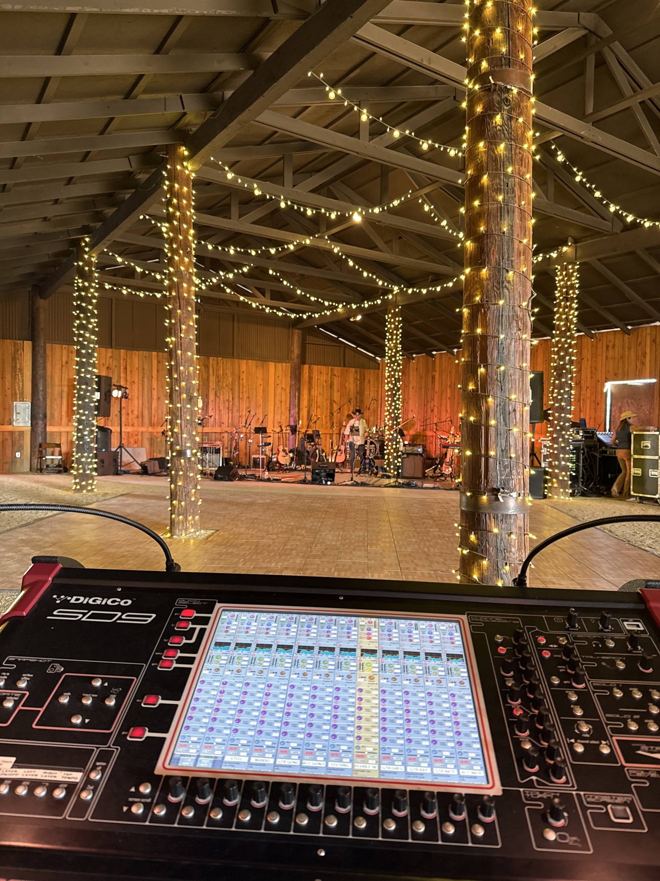DiGiCo mixing console at front of house inside a barn venue